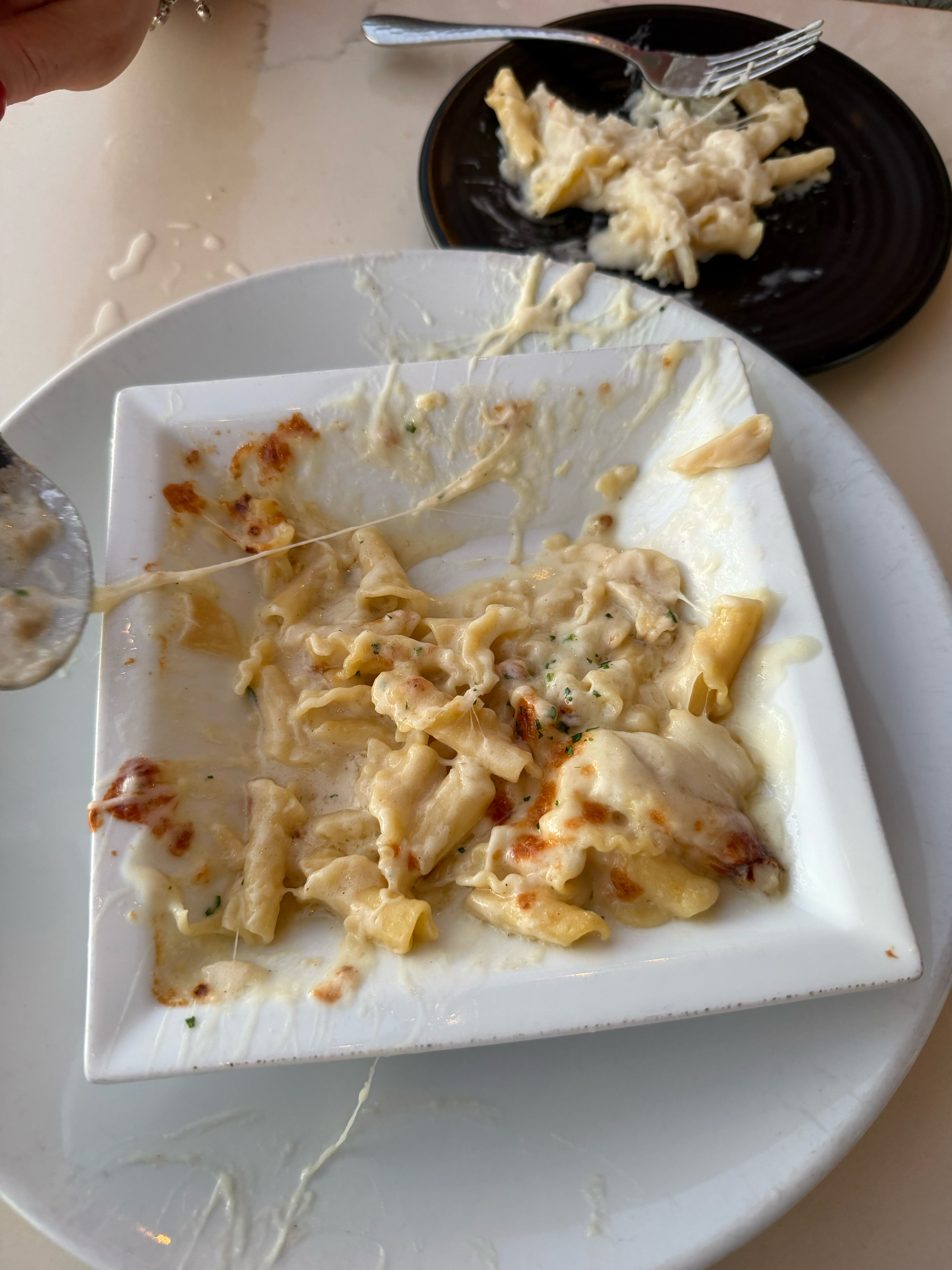 A half eaten Crab Mac & Cheese