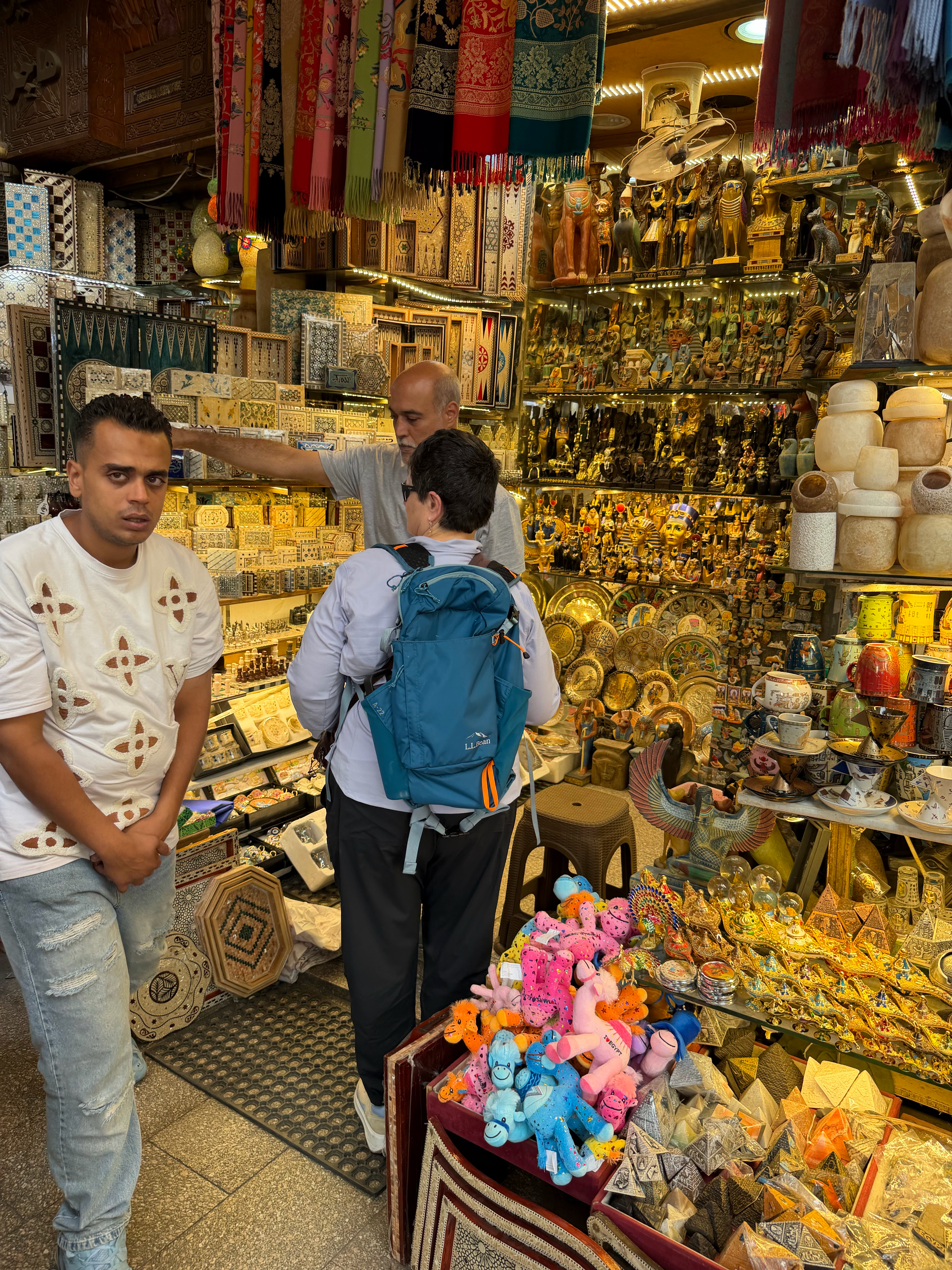 Noel purchasing two head scarves for upcoming temple visits